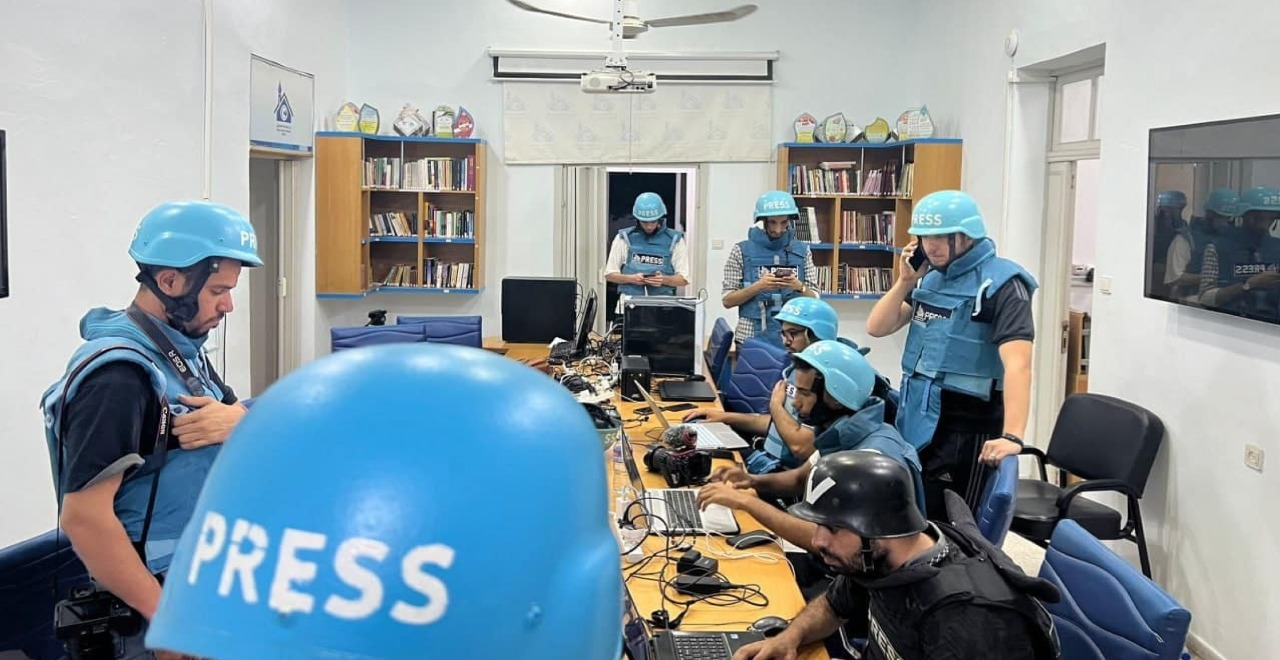 Atef Abu Saif (fourth left) and Bilal Jadallah (third right) in the Press House office on 9 October 2023. Composite: Press House